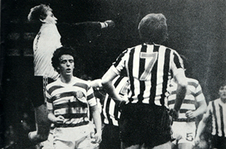 Saints' Billy Thomson clears from former team mate Frank McGarvey